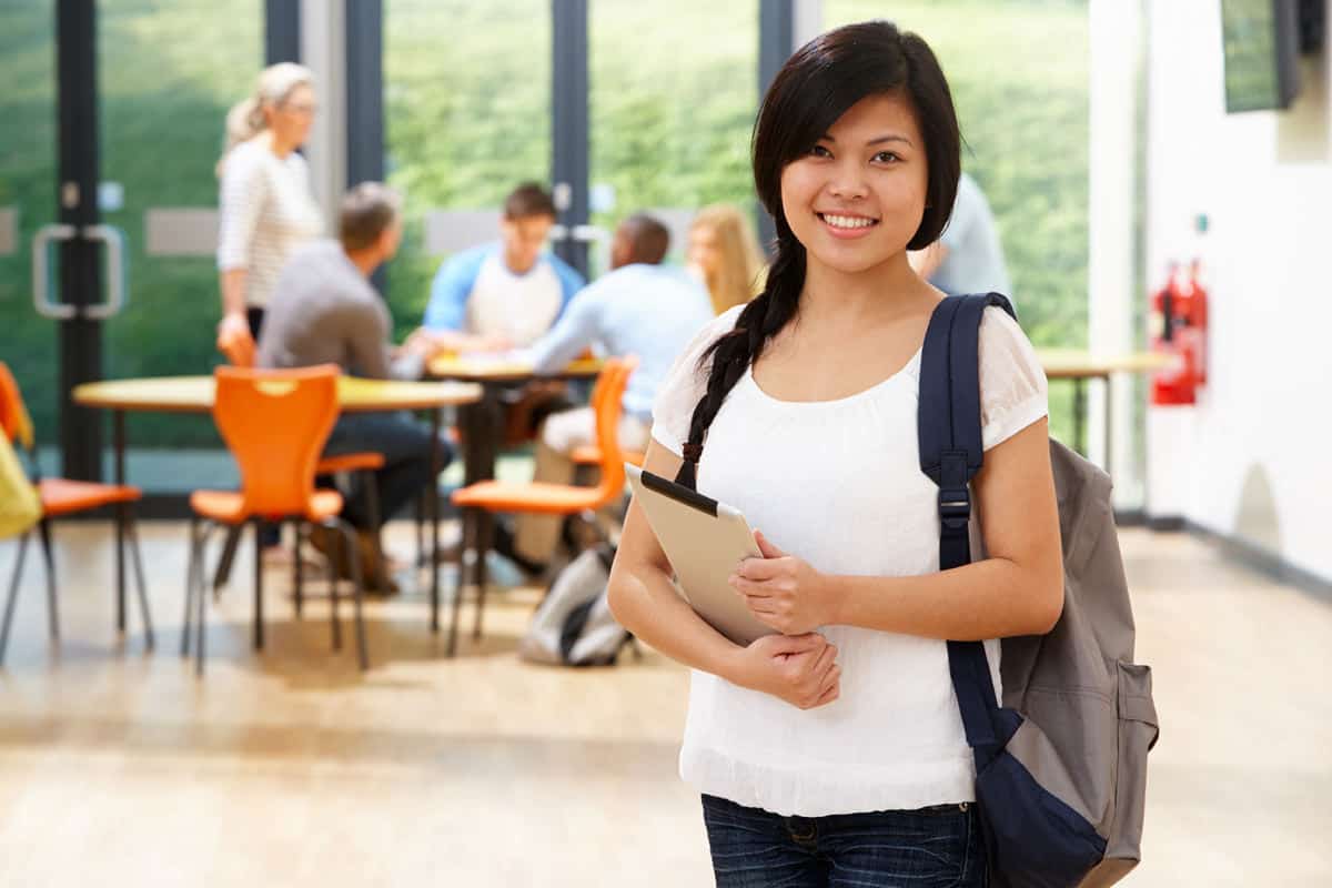 Female Student In Classroom With Digital Tablet