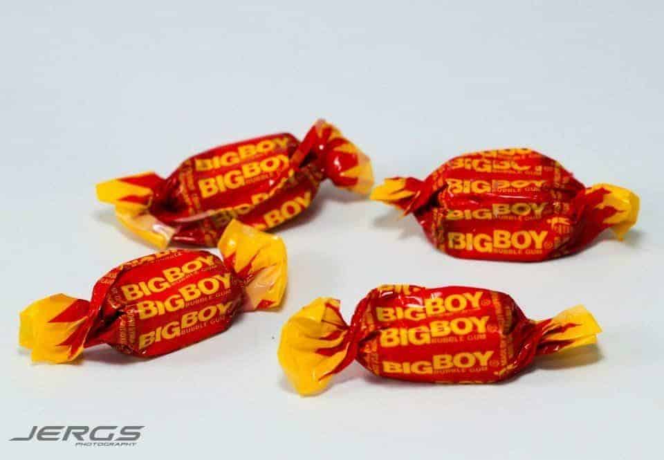 A group of colorful candy wrappers nostalgically placed on a white surface.