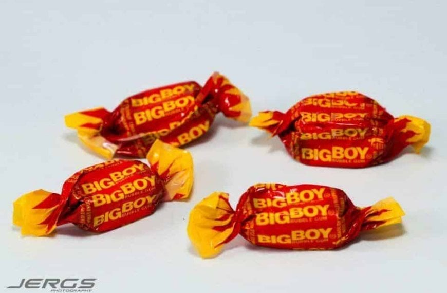 A group of colorful candy wrappers nostalgically placed on a white surface.