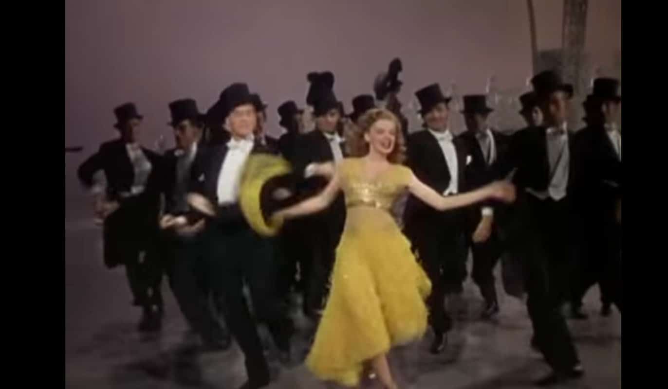 A woman in a yellow dress mashup dancing with men in tuxedos, fusing jazz and funk, while grooving to Uptown Funk.