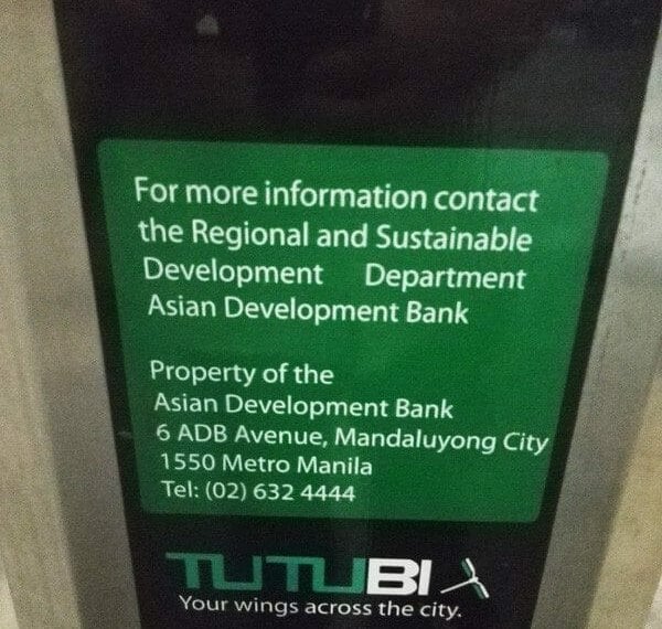 A sign directing people to contact the sustainable development bank.