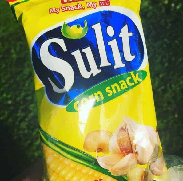 A person holding a bag of sult corn snack, the perfect #sulit snack option.