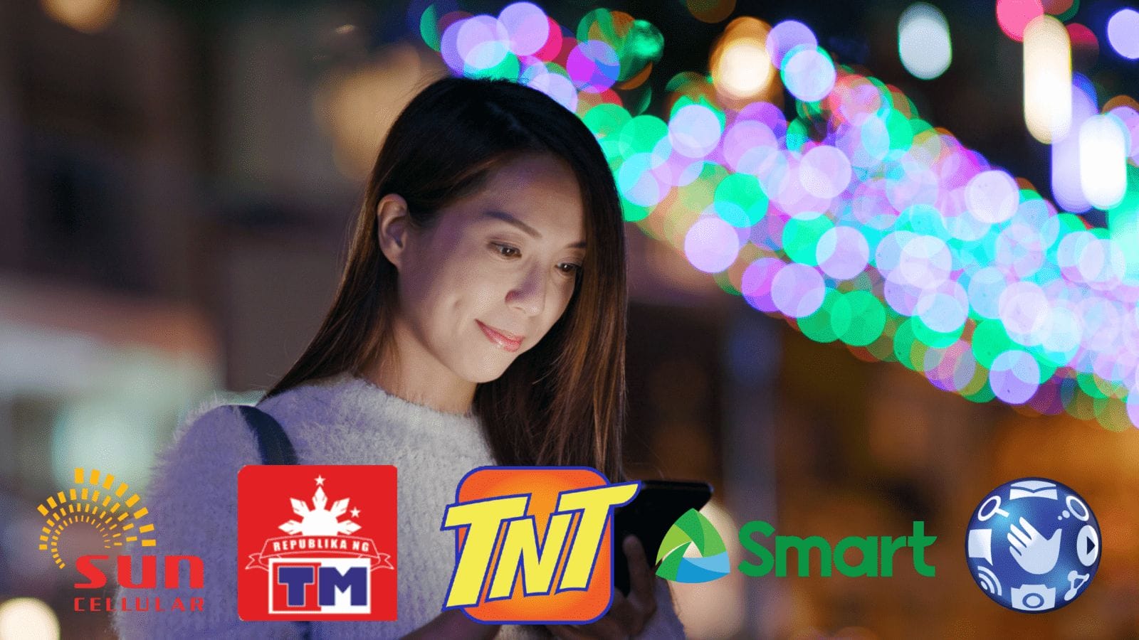 A woman is using a cell phone in the sunlit city.