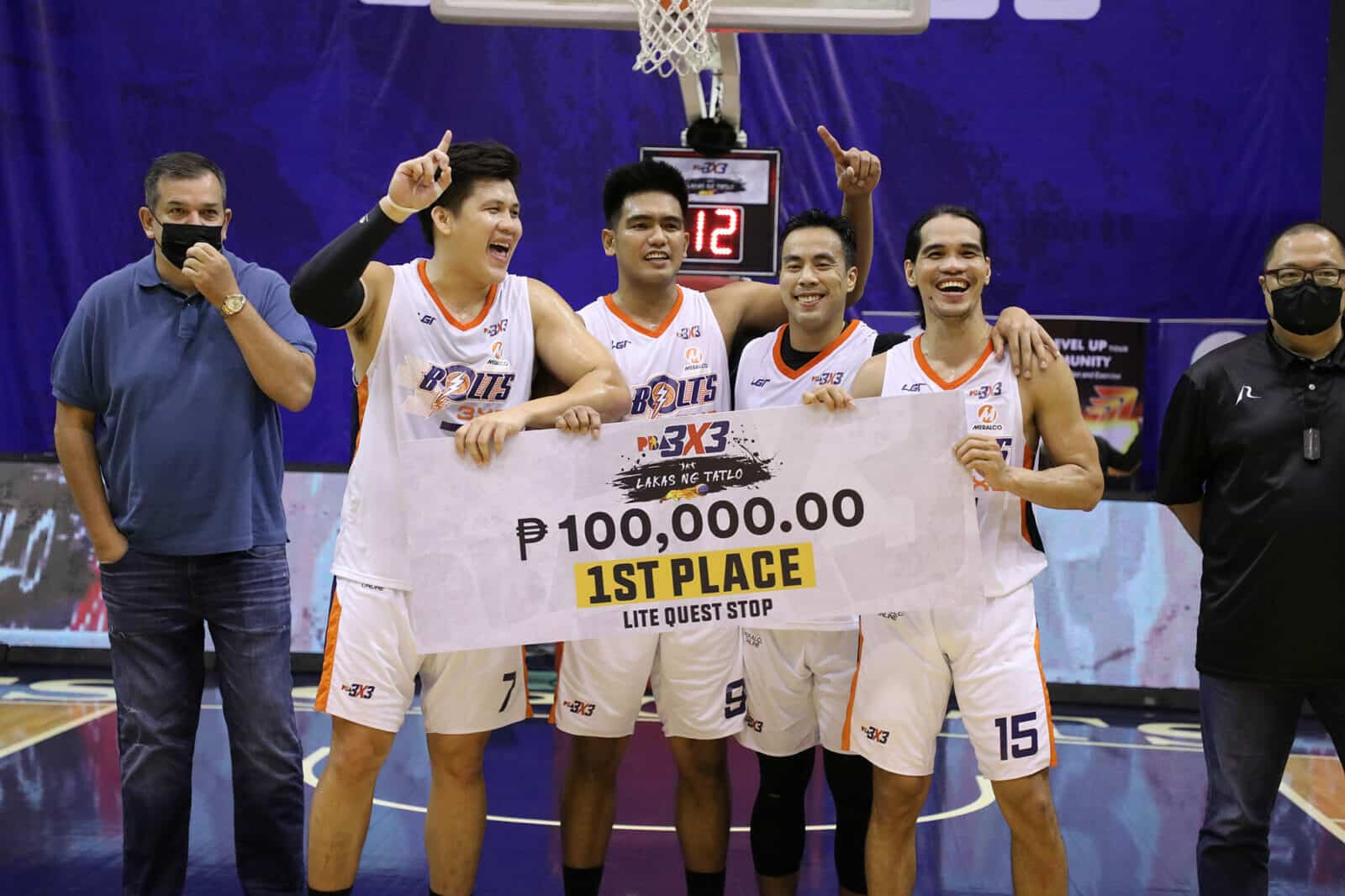 Meralco basketball players celebrate victorious 2nd leg of PBA 3x3 with large check.