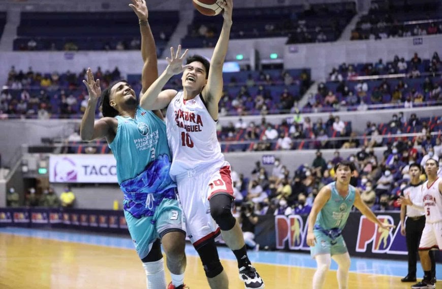 A basketball player named Arvin Tolentino is trying to block a shot.