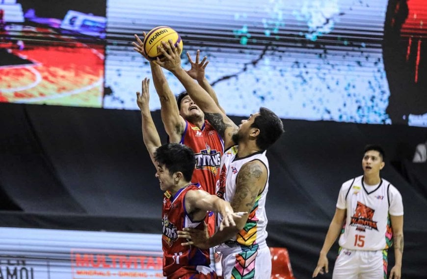 PBA basketball players block ball during fast start in Purefoods' fifth leg.