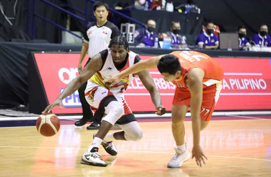 A basketball player successfully steals the ball from another player in San Miguel's win against NorthPort in the PBA Governors' Cup.