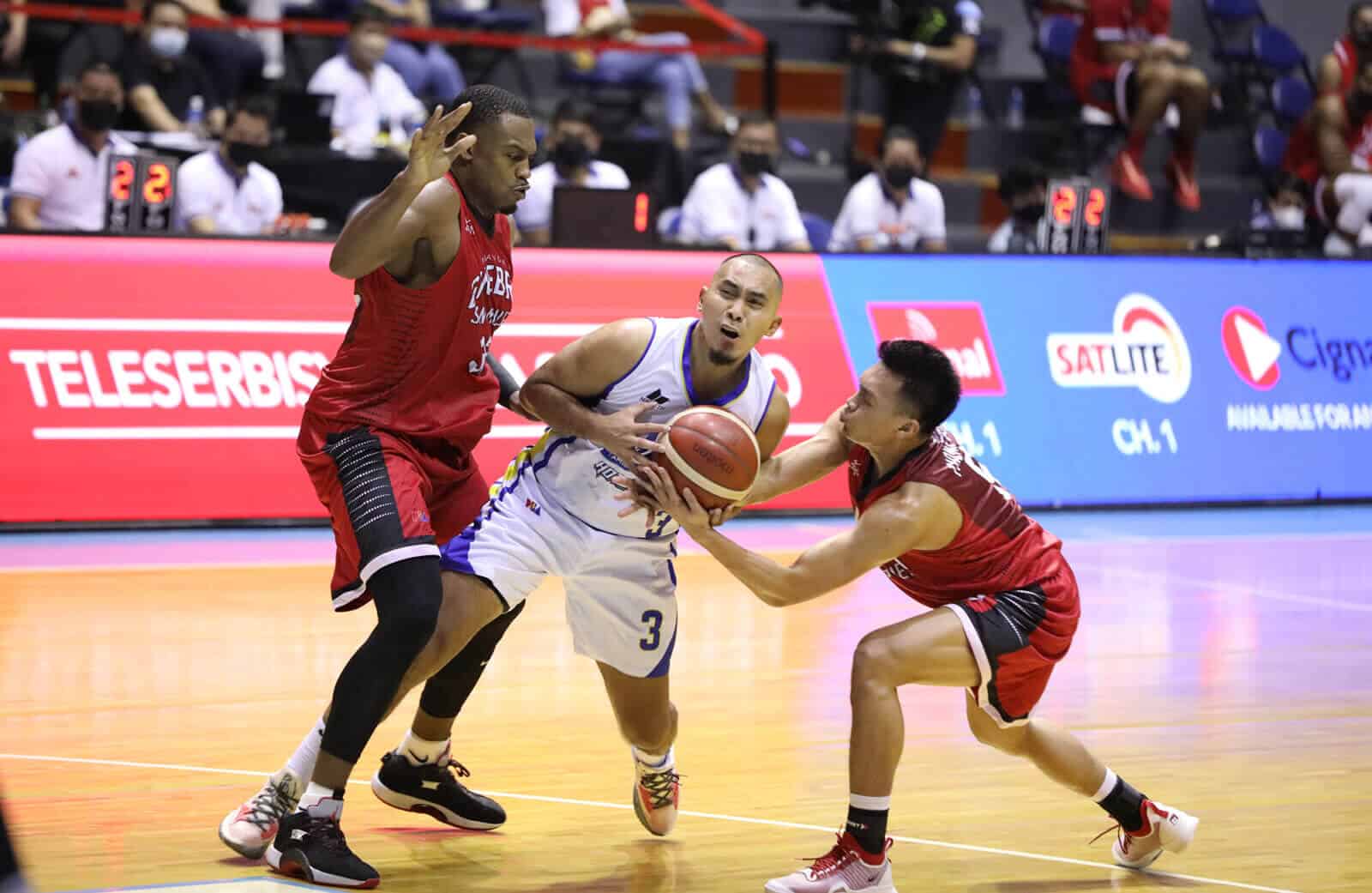 Two basketball players are competing in a crucial PBA match.