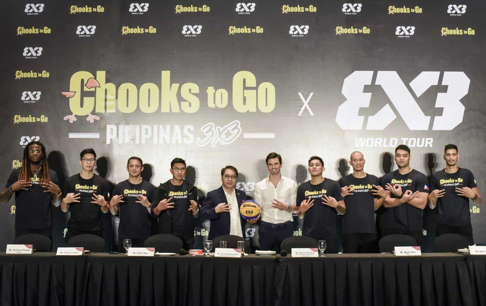 A group of basketball players posing for a picture at the Chooks-to-Go-FIBA 3x3 global partnership.