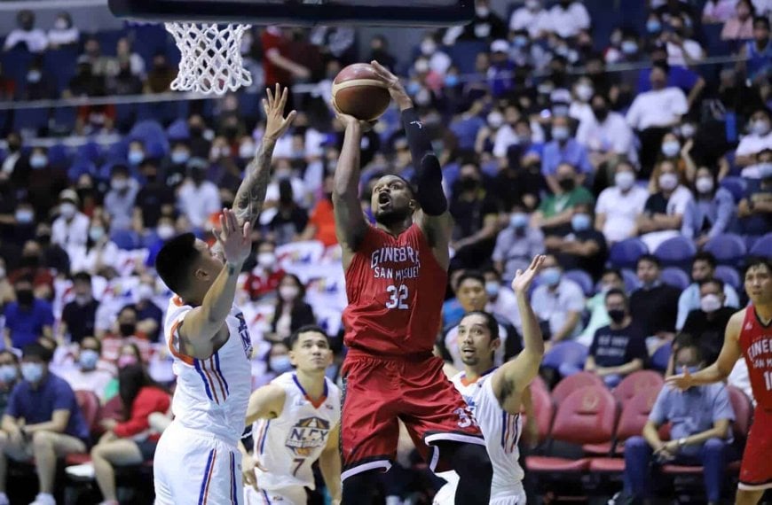 A basketball player successfully blocks a shot during a game, helping Ginebra secure a spot in the PBA Governors' Cup finals.