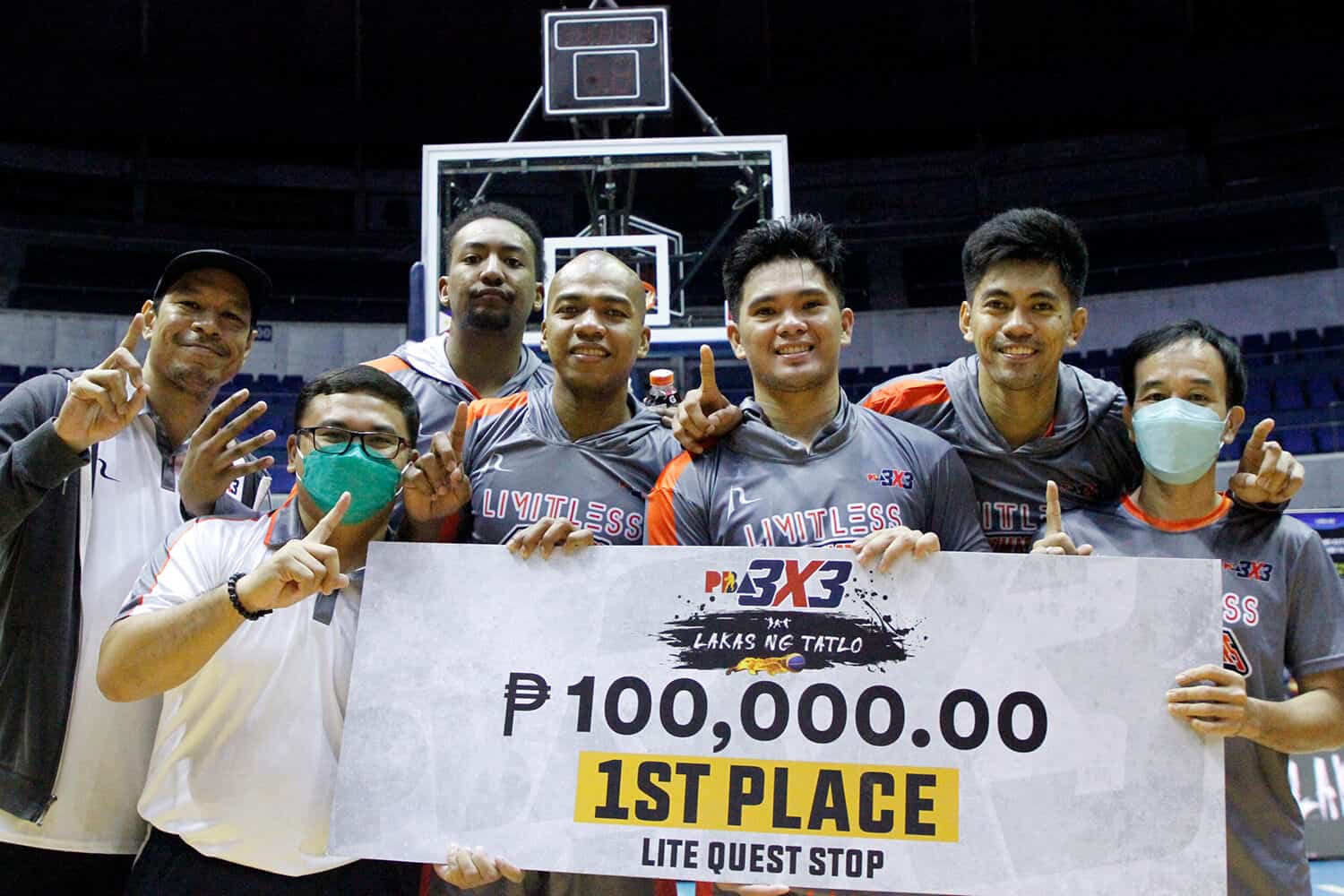 A group of basketball players posing with a large check after winning the Leg 3 title of PBA 3x3 Conference.