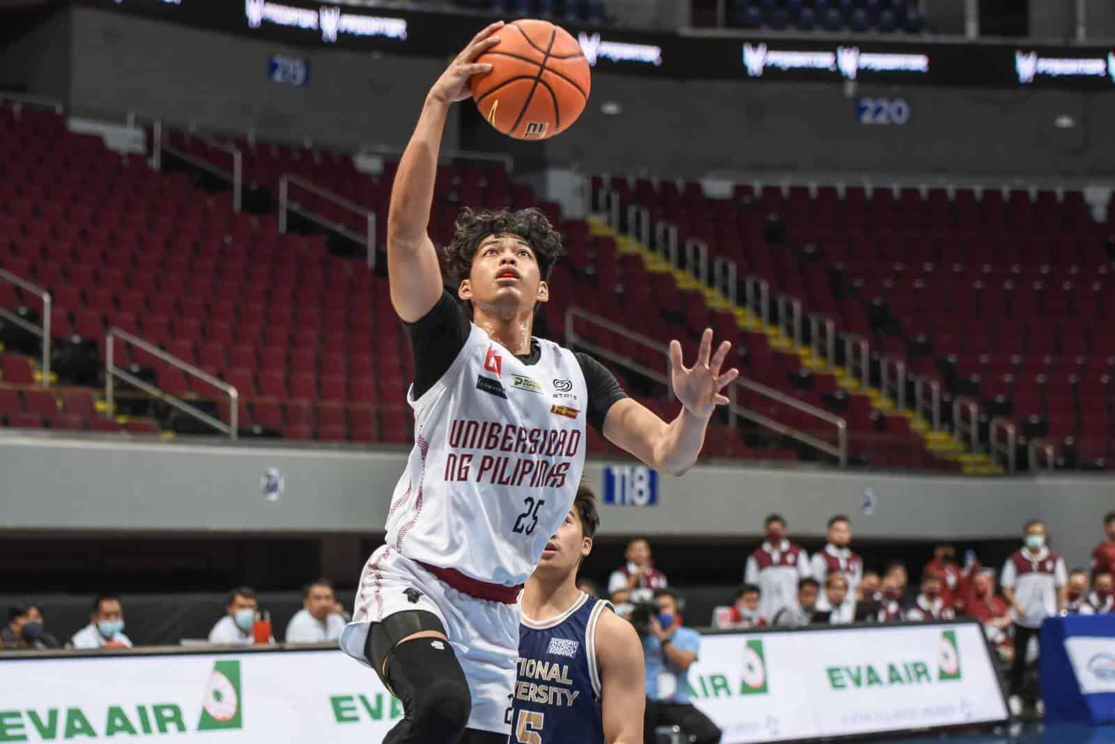 A basketball player from the UP Fighting Maroons is about to shoot the ball in a game against NU.