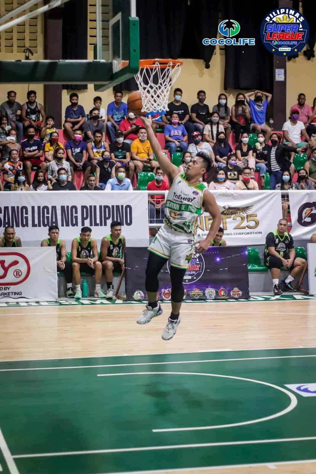 A basketball player dunking the ball in the Pilipinas Super League Pearl of the Orient Cup.