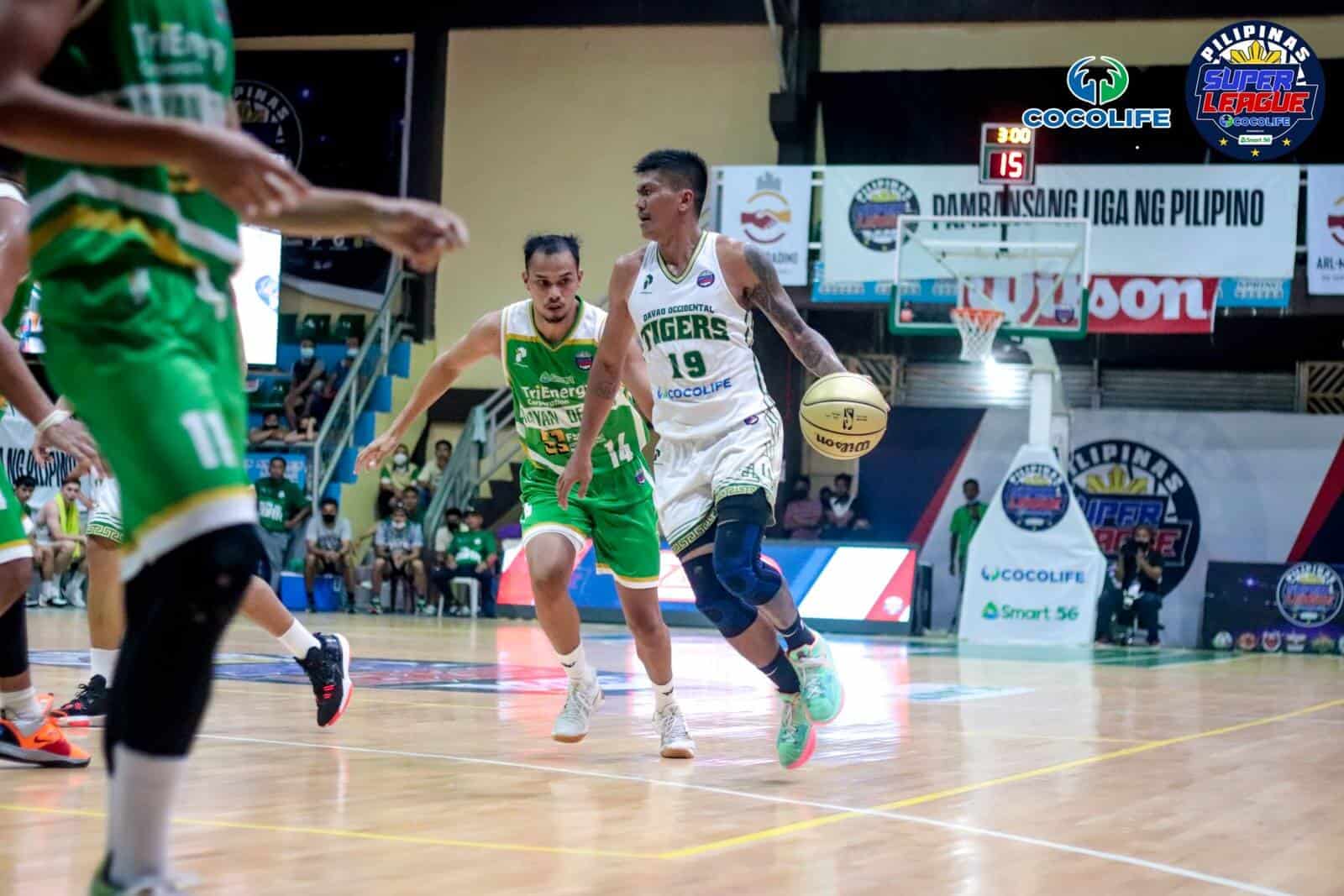 A basketball player dribbles the ball on a court in Game 1 of PSL Finals.