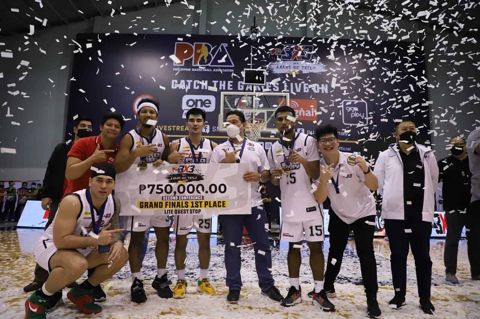 A group of basketball players joyfully posing with confetti after Pioneer Pro Tibay's championship win in the PBA 3x3 Second Conference Grand Finals.