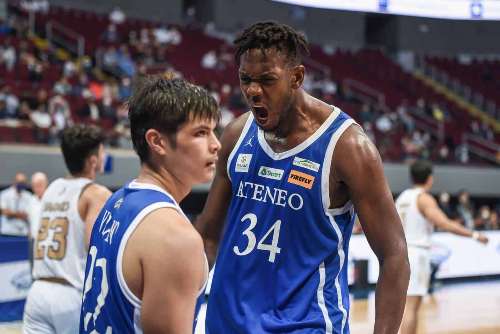 A basketball player converses with a teammate during a gritty win for Ateneo Blue Eagles against NU Bulldogs.