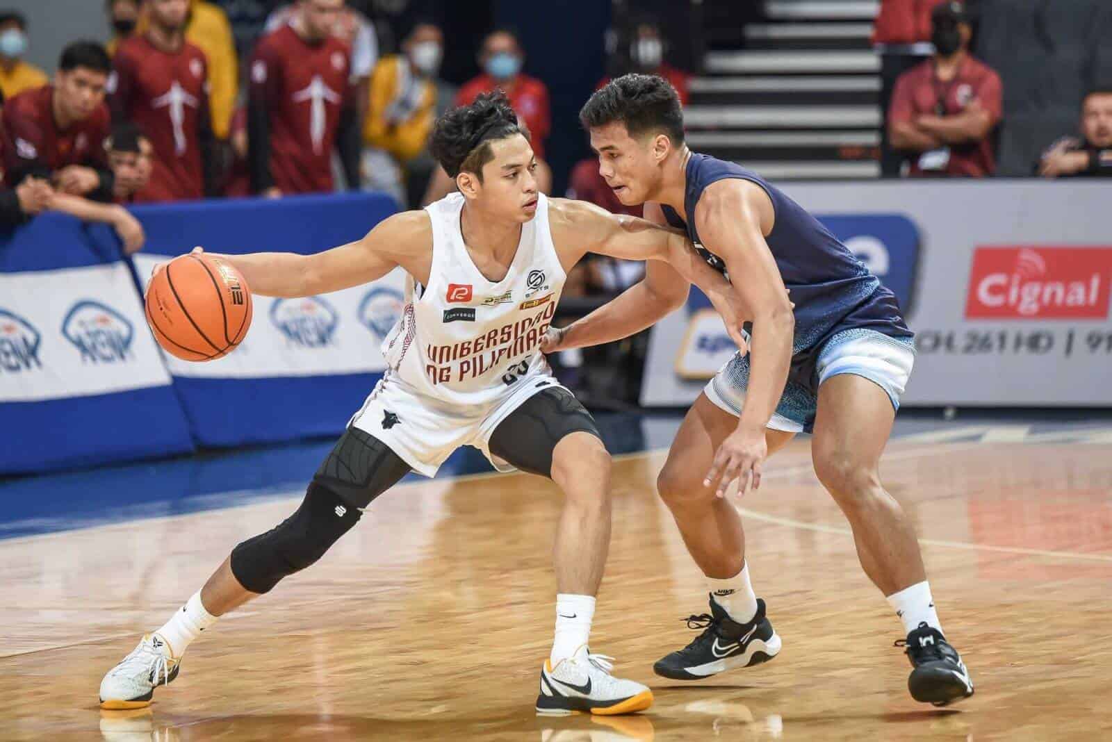 Two basketball players showcase action on the court with a nailbiter win for UP against Adamson.