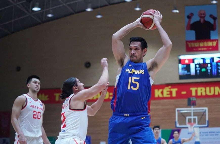 A basketball player tries to block a shot in an overwhelming game against Vietnam in SEA Games.