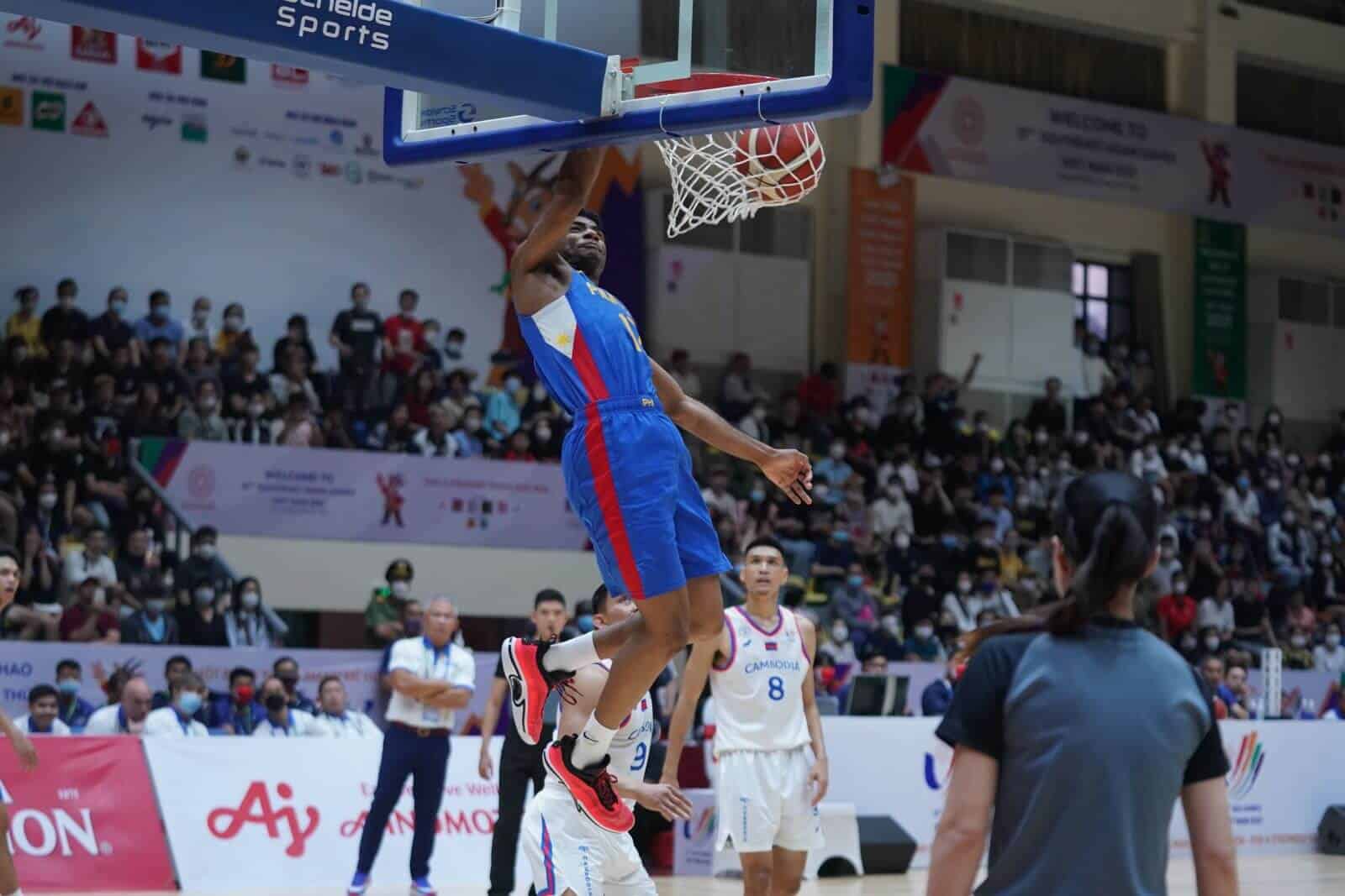 A basketball player showcases their dunking skills to an excited crowd.