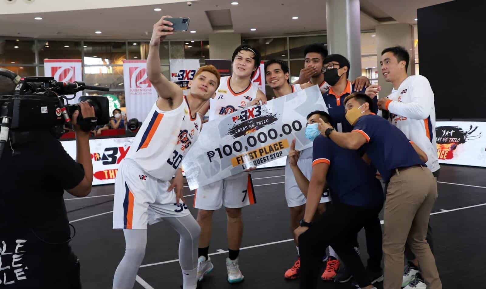 A group of basketball players celebrating their victory in the PBA 3x3 Third Conference.