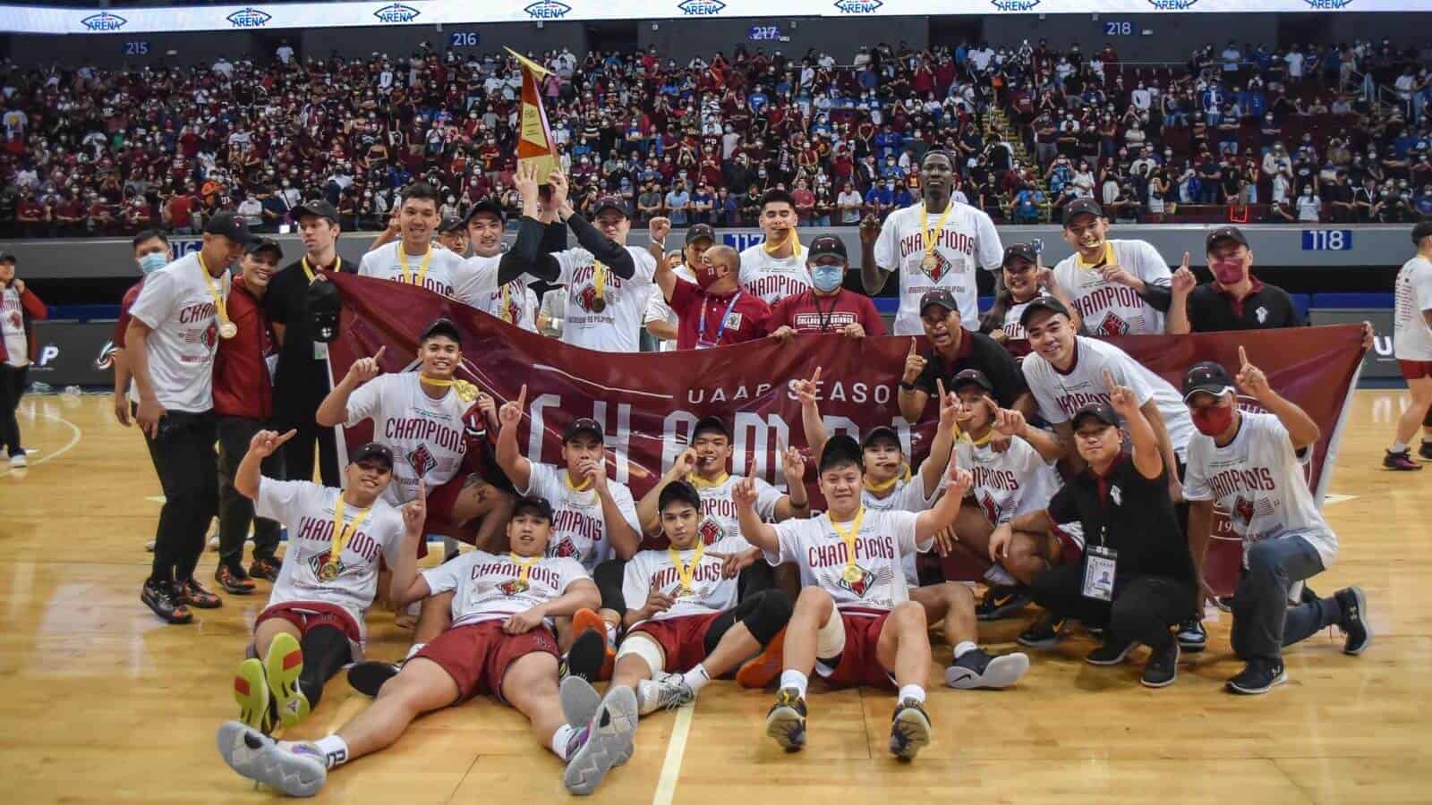 A group of basketball players posing for a picture after UP Maroons end 36-year title drought by winning the UAAP men's basketball crown over Ateneo.