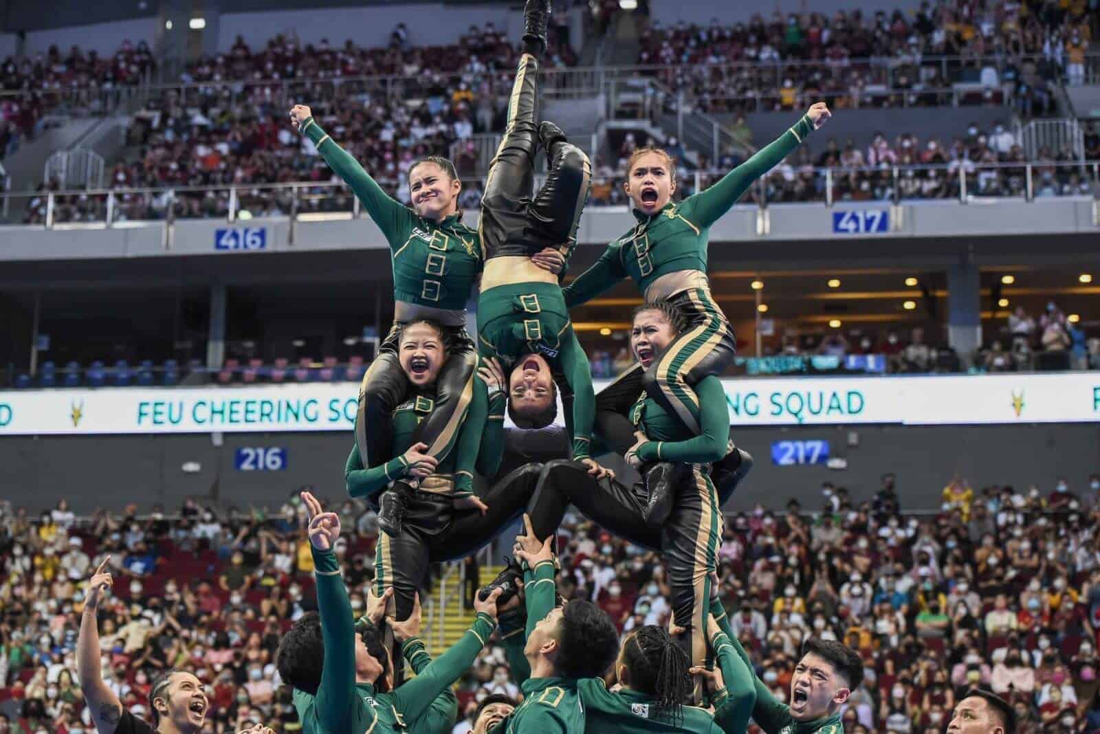 FEU wins UAAP Cheerdance Competition with a group of cheerleaders performing in front of a crowd.