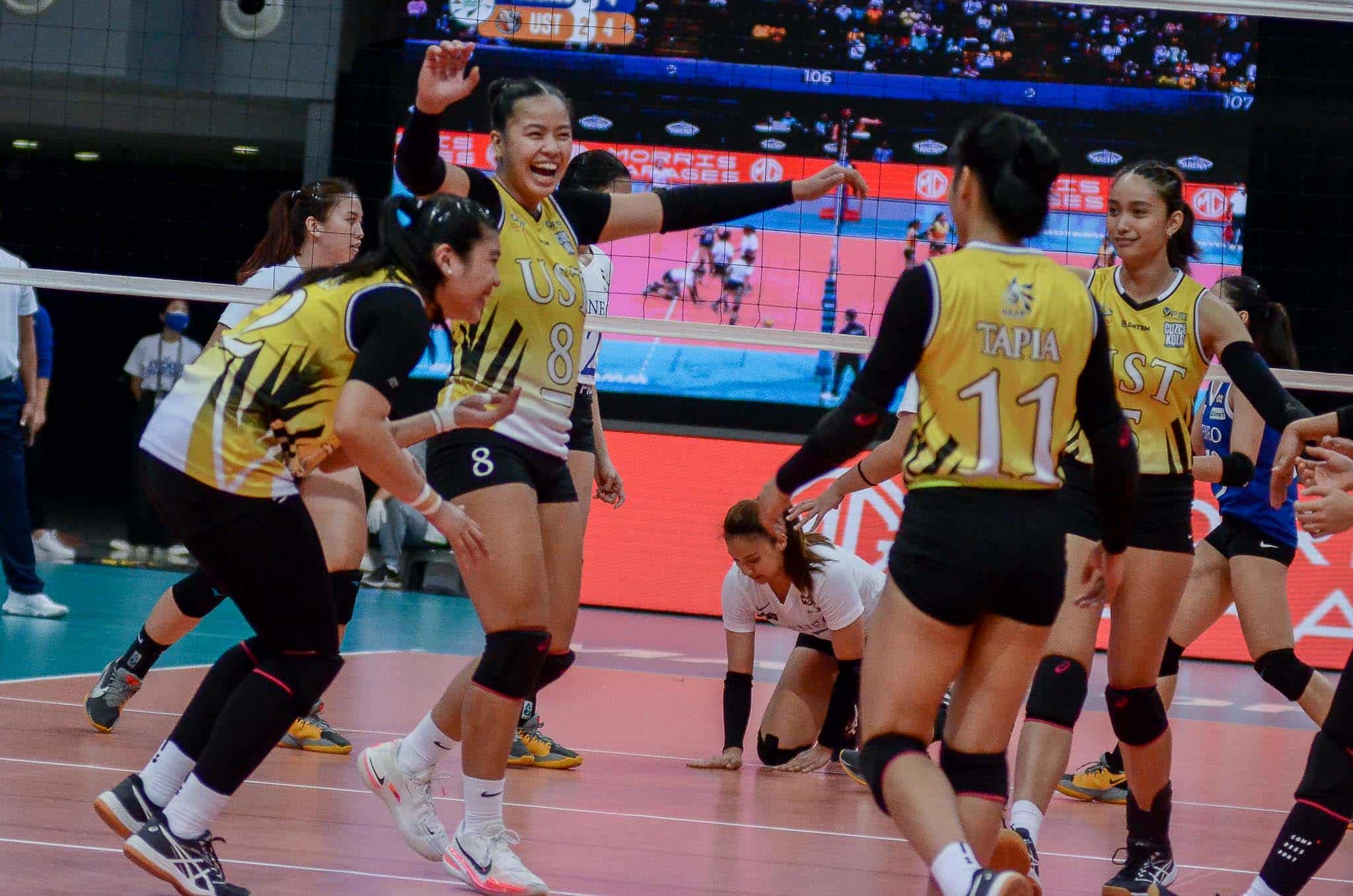 UST celebrates win against Ateneo in UAAP women's volleyball.