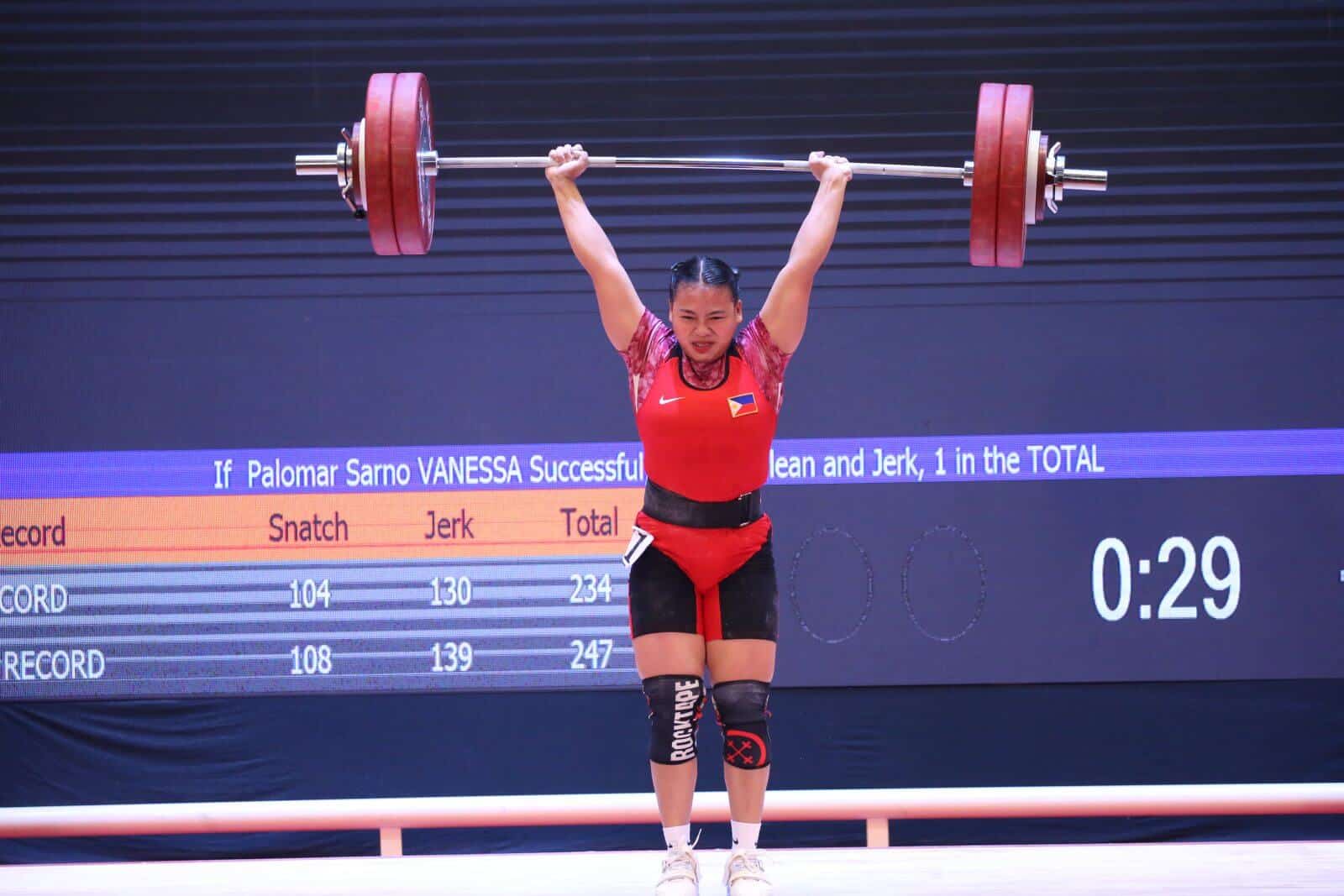 A woman competing in weightlifting at a PH SEAG event in Vietnam.