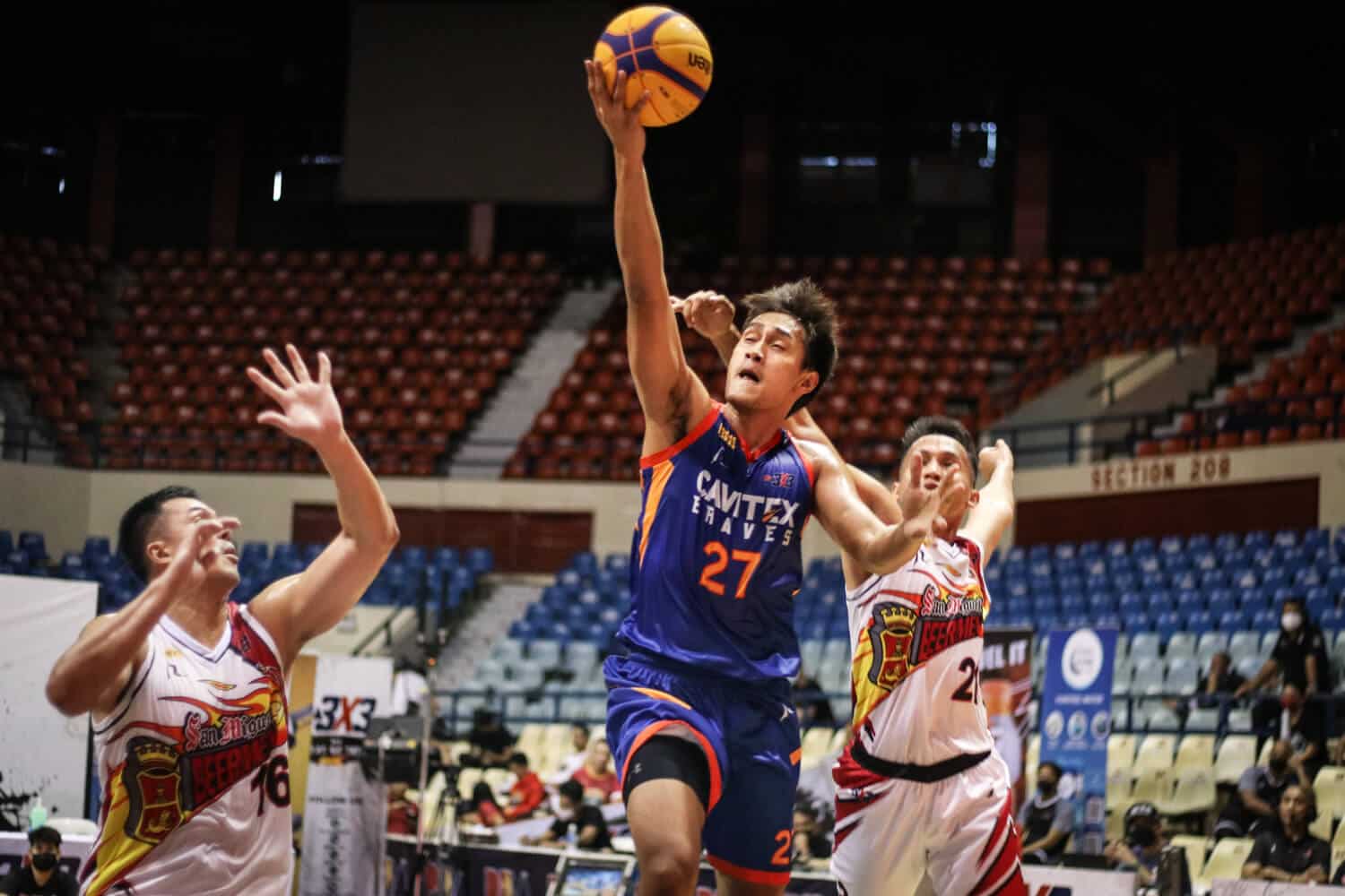 A basketball player is trying to block a ball during a PBA 3x3 Third Conference game.