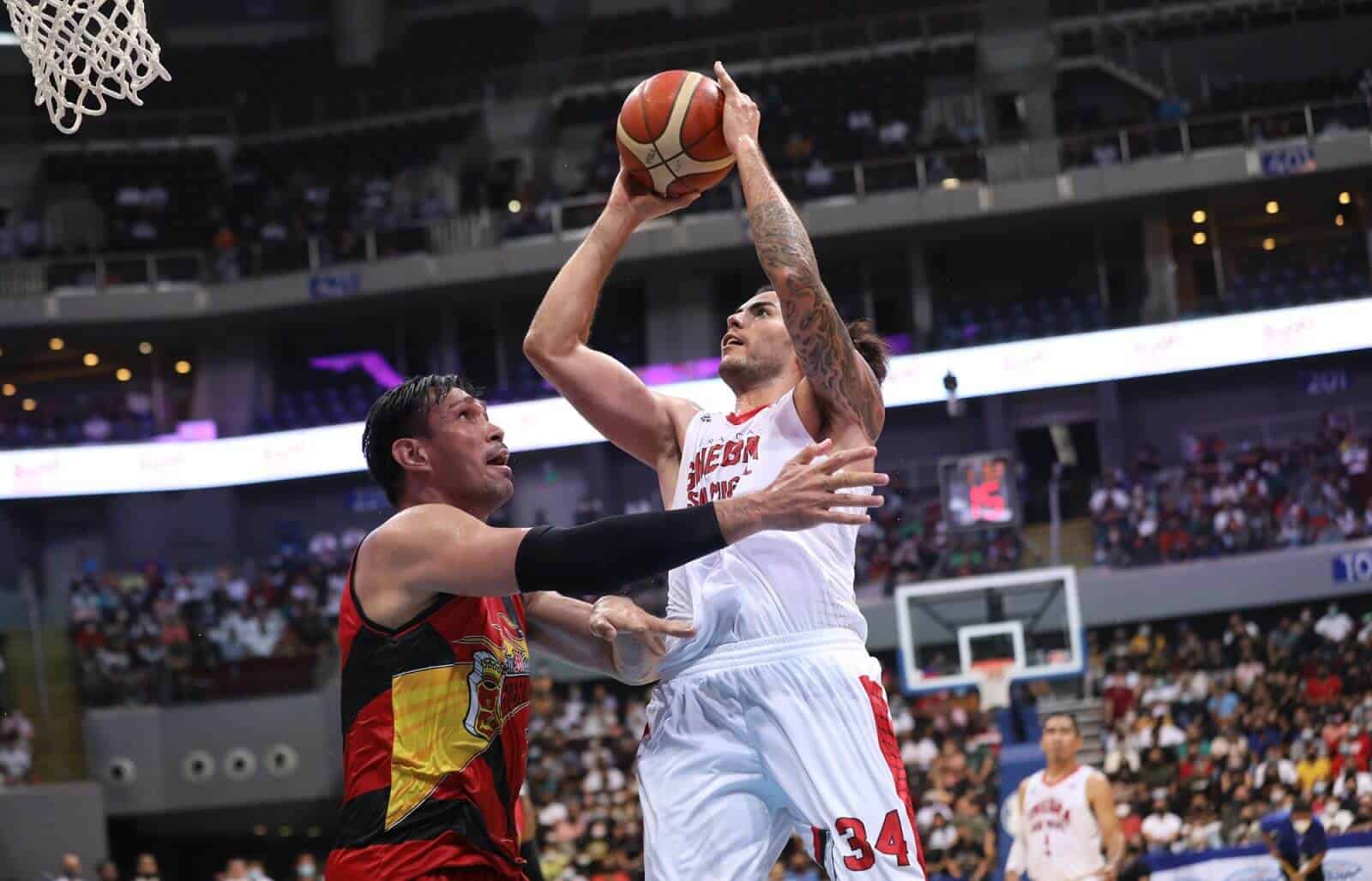 A basketball player blocks a shot in a game against San Miguel.