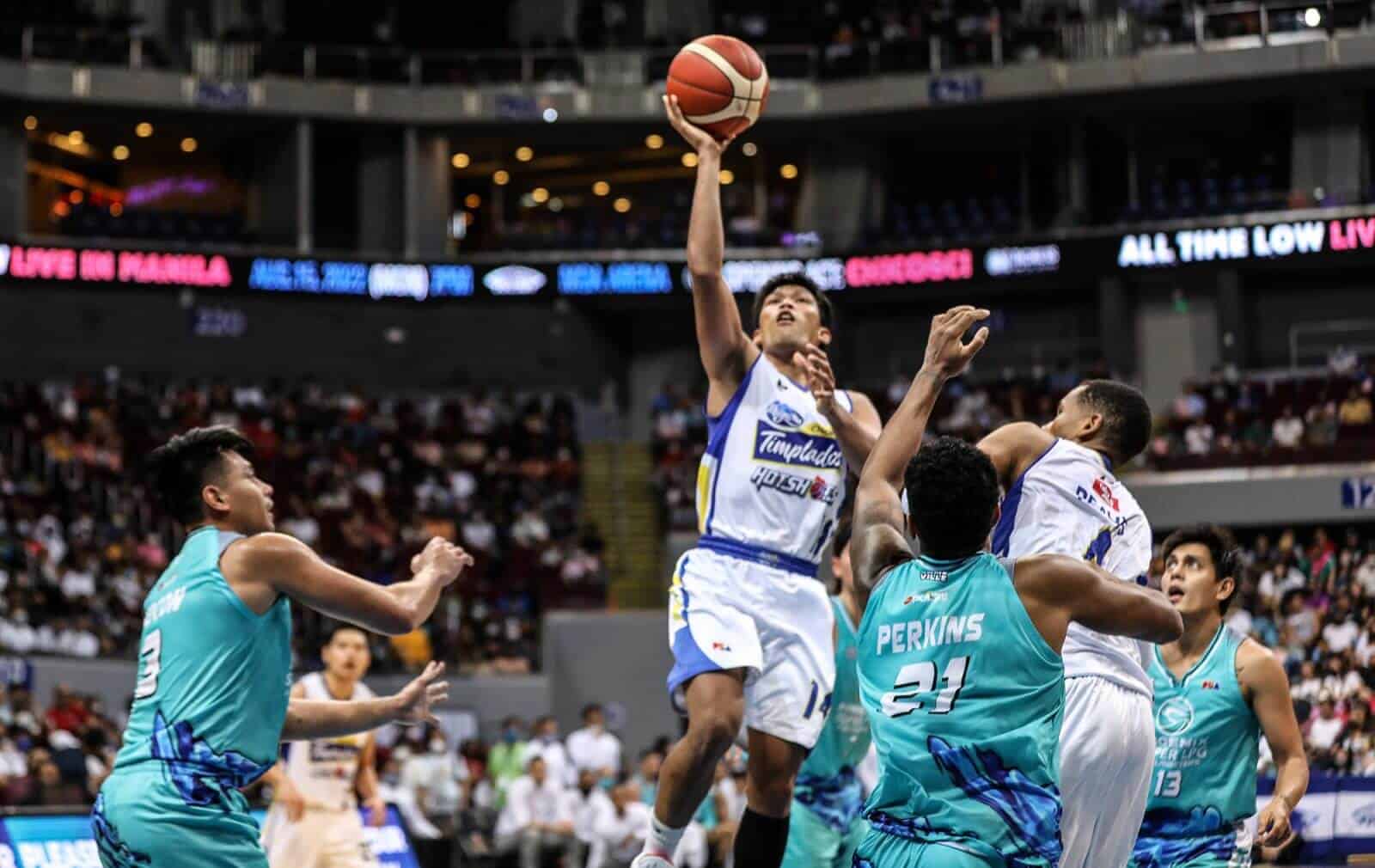A basketball player fiercely blocks a shot during an Undermanned Magnolia victory in the PBA Philippine Cup.