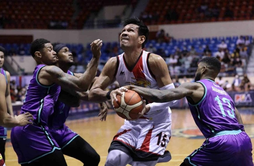 Basketball players in purple uniforms competing for ball in PBA Philippine Cup standings.