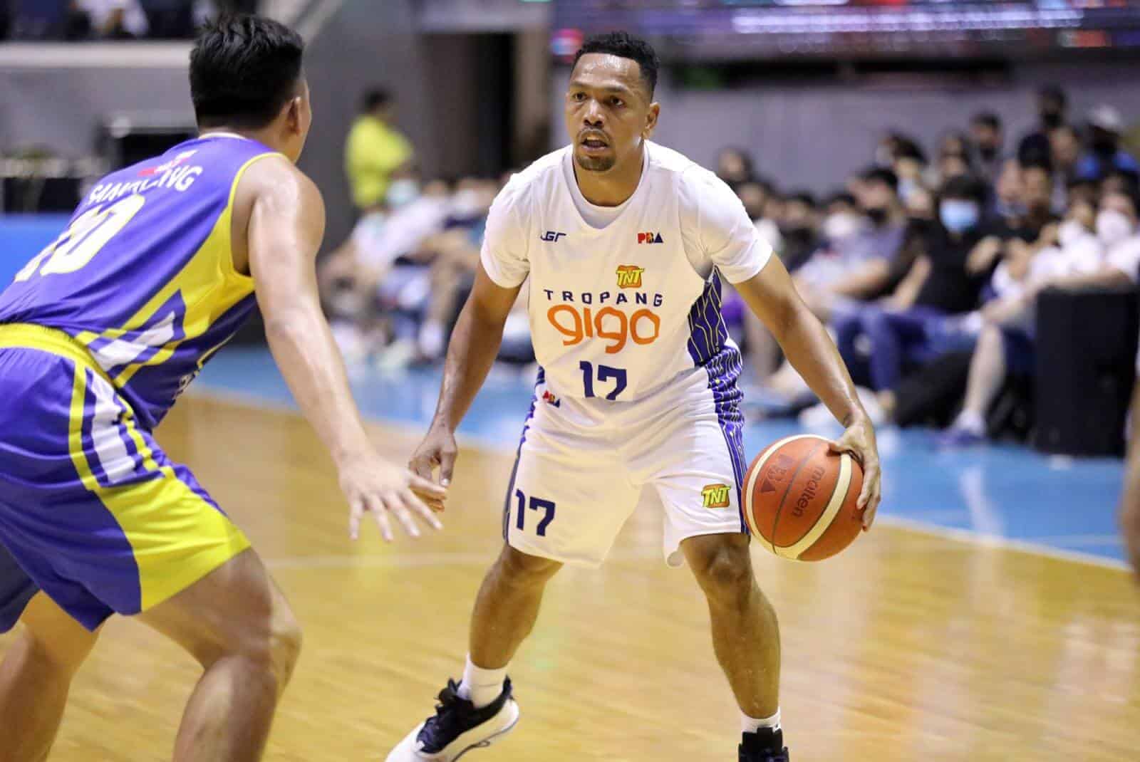 A basketball player named Scottie Thompson dribbles the ball in a thrilling PBA Philippine Cup game victory for TNT over Magnolia, earning him the MVP title.