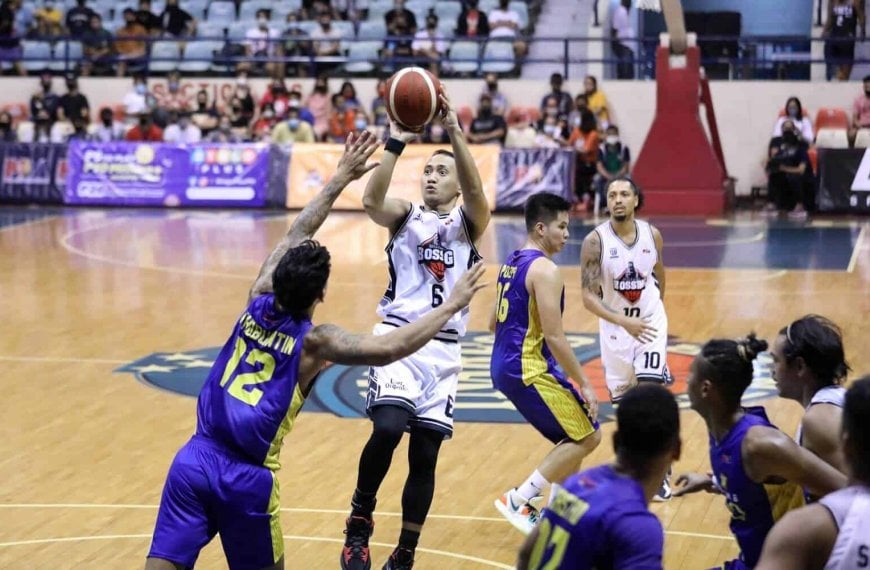 A basketball player is attempting to block a shot during a game in the PBA Philippine Cup campaign.