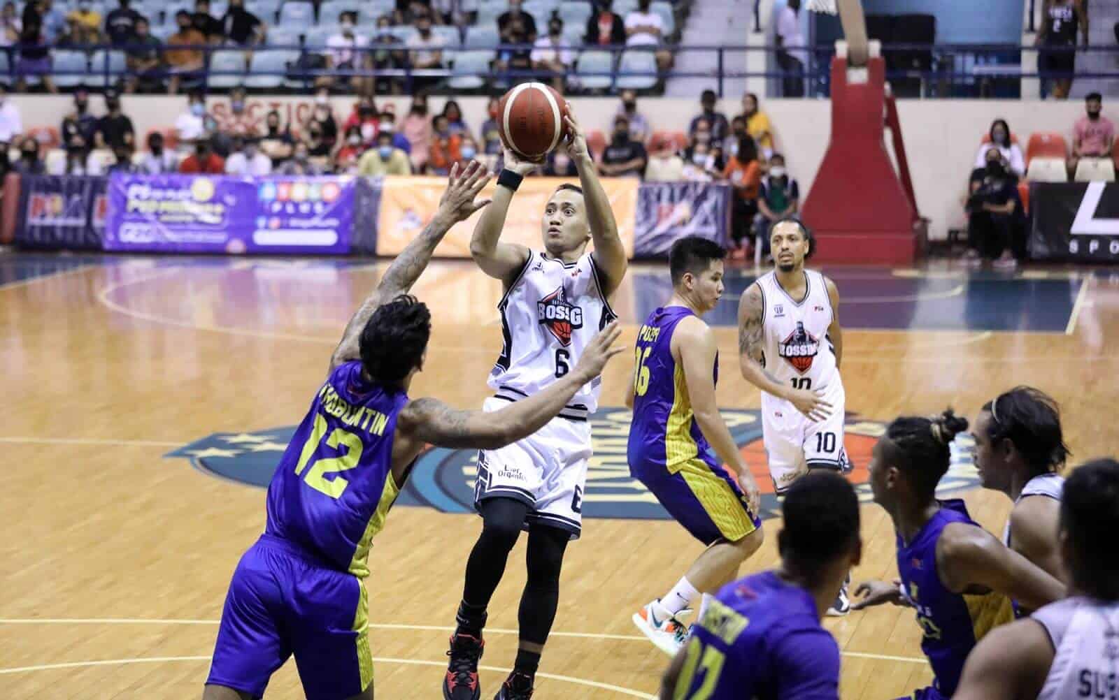 A basketball player is attempting to block a shot during a game in the PBA Philippine Cup campaign.