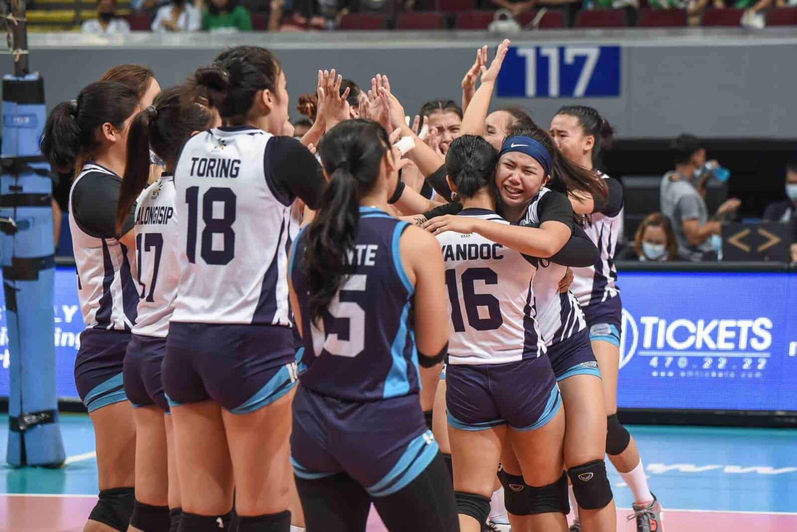A group of female volleyball players celebrates their gritty win over La Salle, keeping Adamson's Final Four hopes alive.