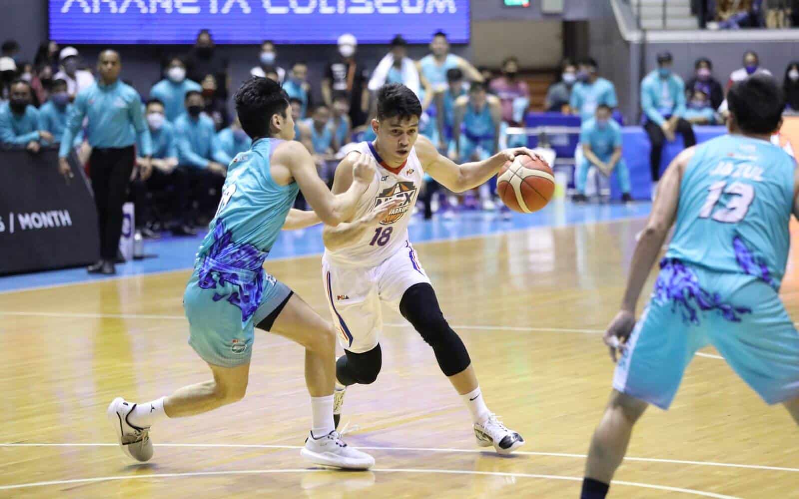 Two Asian basketball players showcase their skills on the court in a thrilling victory by NLEX.