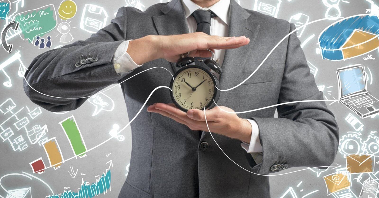 A man in a gray suit holds a traditional alarm clock with both hands against a background filled with various colorful doodles, including charts, graphs, a light bulb, a laptop, and other business-related symbols. The clock's hands point to 10:10. Lines connect the clock to the doodles, symbolizing 2023 business ideas.