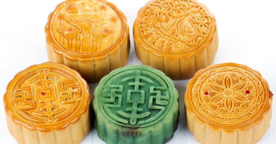 five chinese mooncakes on a white background, also known as the mooncake festival or moon festival.