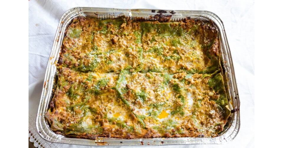 a casserole dish filled with green beans and cheese, perfect for any foodie's paradise gathering in metro manila.