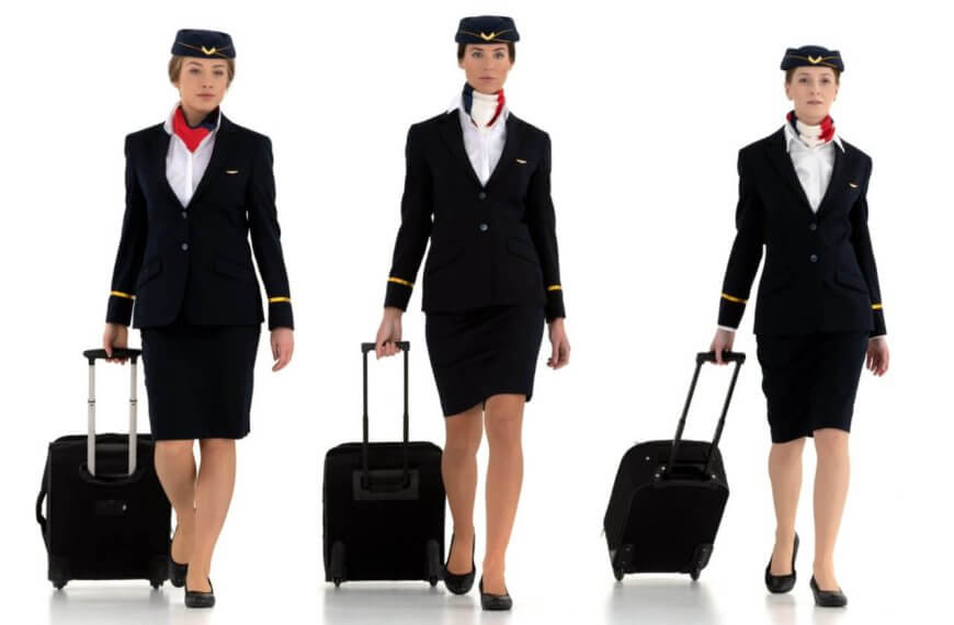 A group of Philippines airline attendants with luggage.