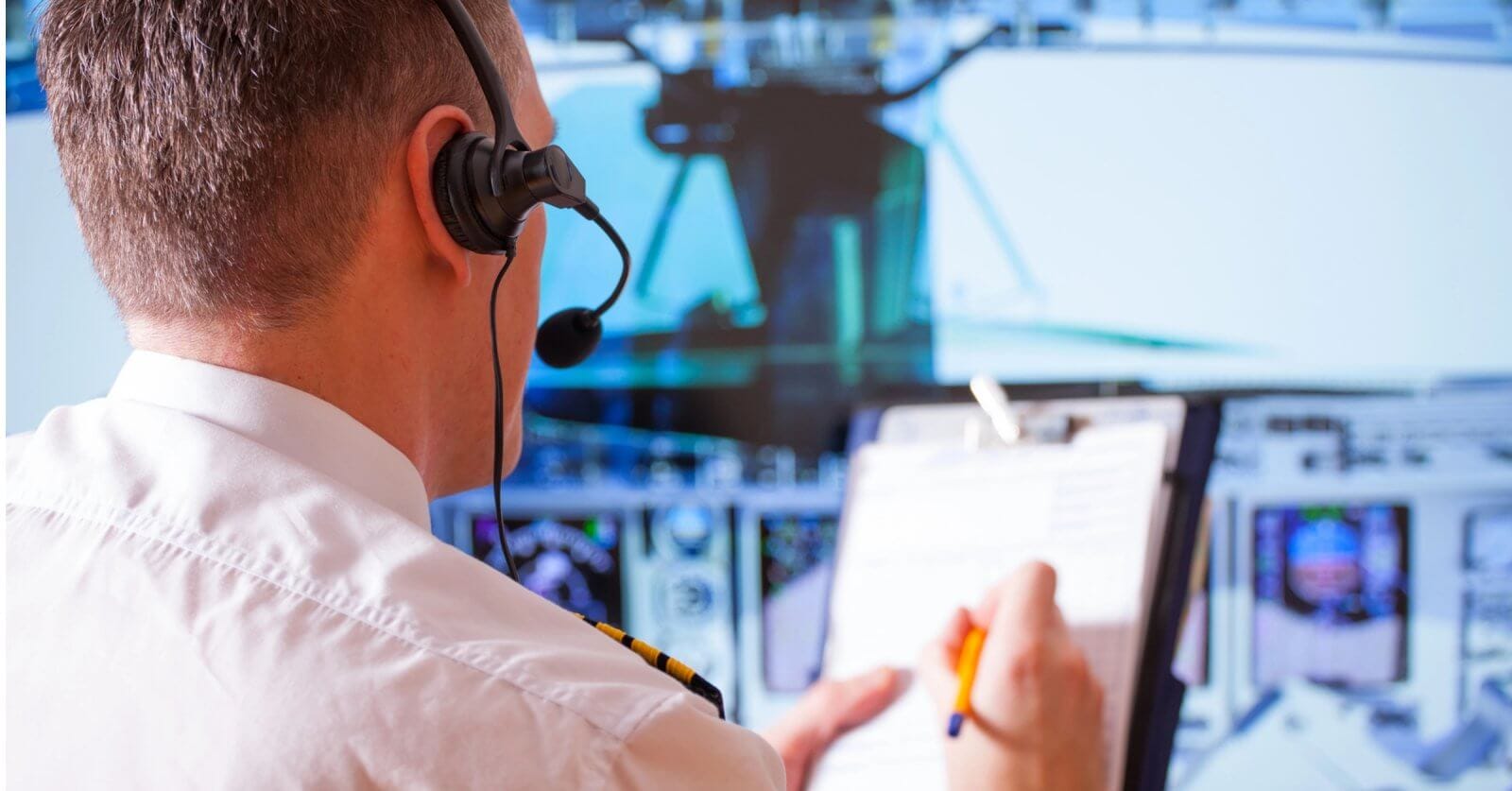 A man wearing a headset and holding a pen at an Aviation Dreams event in the Philippines.