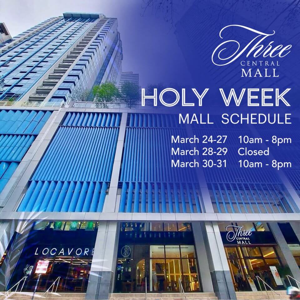 A modern high-rise building with signage displaying the three central mall schedule, set against a clear blue sky.