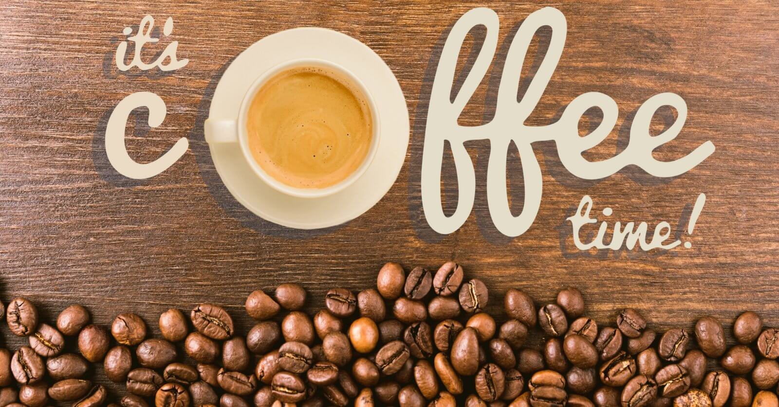 A white cup of coffee sits on a wooden surface, surrounded by scattered coffee beans. The words "it's coffee time!" are artistically written in beige lettering around the cup. The composition creates a cozy and inviting atmosphere that celebrates Antipolo's best coffee shops.