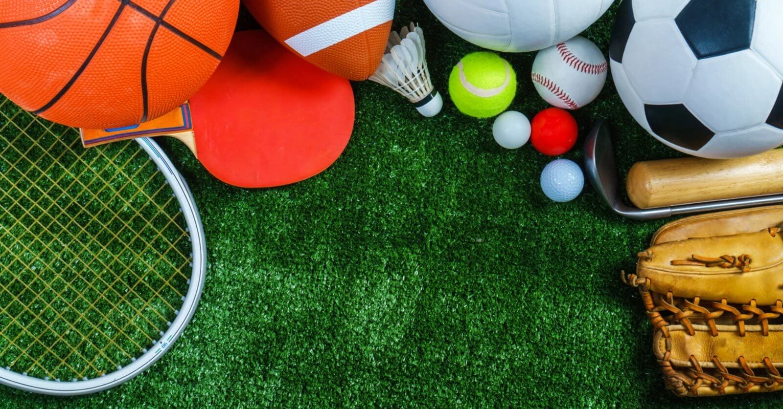 A variety of sports equipment arranged on a green grass surface. Items include a basketball, yoga mat, American football, soccer ball, badminton birdie, table tennis paddle, baseball glove, tennis ball, golf balls, cricket bat. Perfect for enthusiasts in Metro Manila's sports centers.