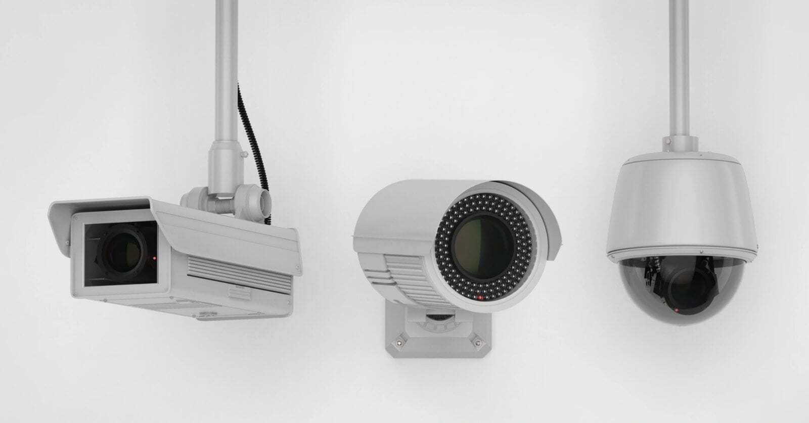 Three security cameras mounted on white walls. The leftmost camera has a rectangular housing; the one in the middle is cylindrical with an array of infrared LEDs around the lens; the rightmost camera is dome-shaped, enclosed in a transparent, spherical casing—an ideal setup by a top CCTV supplier in Metro Manila.