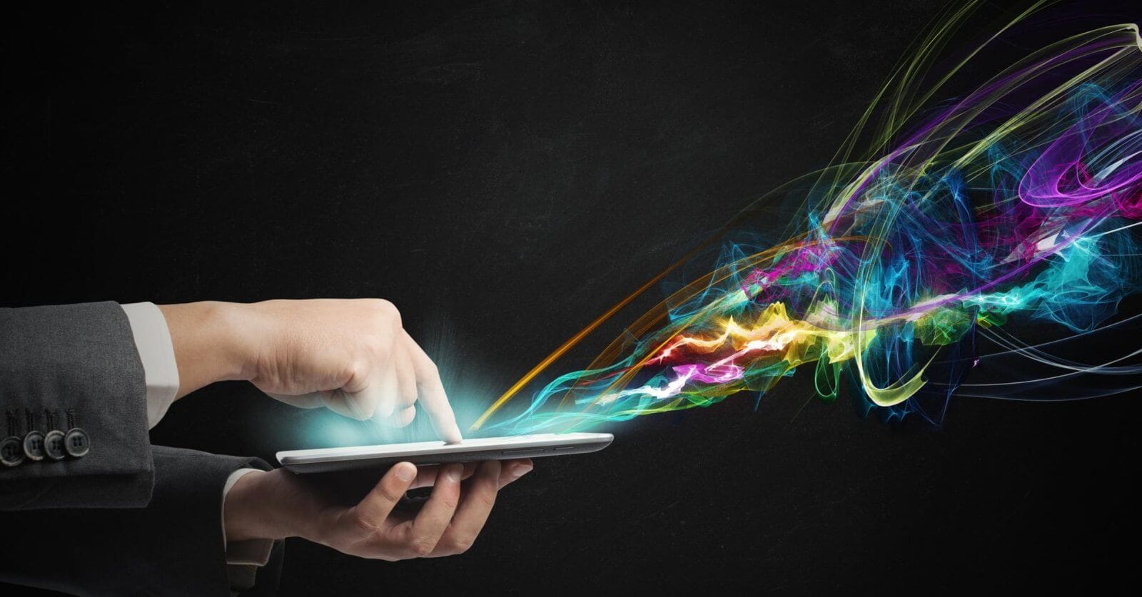 A person in a suit uses a tablet, with colorful, swirling light trails emanating from the screen against a dark background. This vibrant display of blues, greens, yellows, pinks, and purples resembles the dynamic pulse of IT companies in Metro Manila.