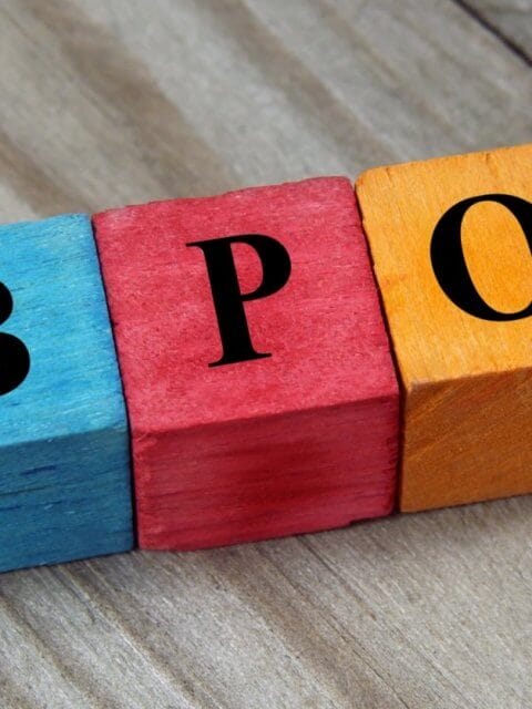 Colorful wooden blocks on a wood surface spell BPO in bold black letters, symbolizing the dynamic career growth opportunities offered by BPO companies in Makati City.