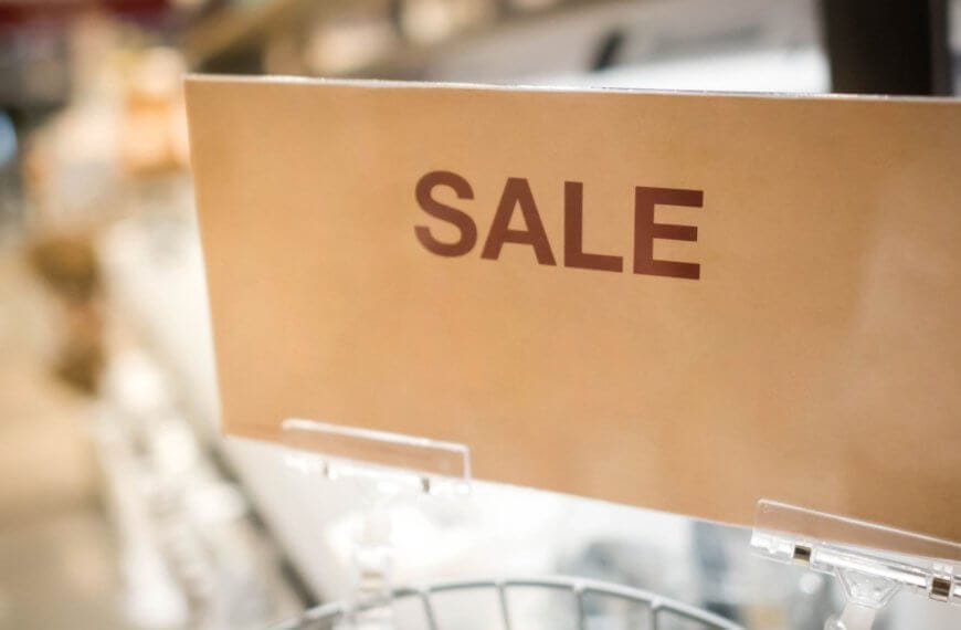 In a bustling Metro Manila outlet store, a vibrant sign reads SULIT DEAL while blurred shelves loaded with treasures sit invitingly in the background.